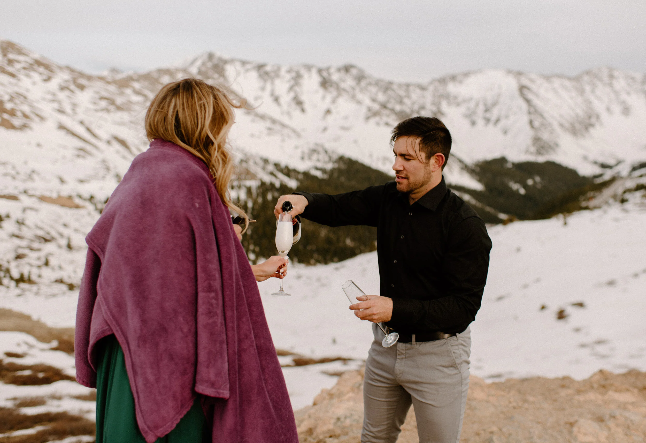  Snowy engagement session on Loveland Pass. Loveland Pass engagement photos. Champagne engagement photo ideas. Colorado wedding photographer. Colorado mountain engagement session. Winter engagement photos.  
