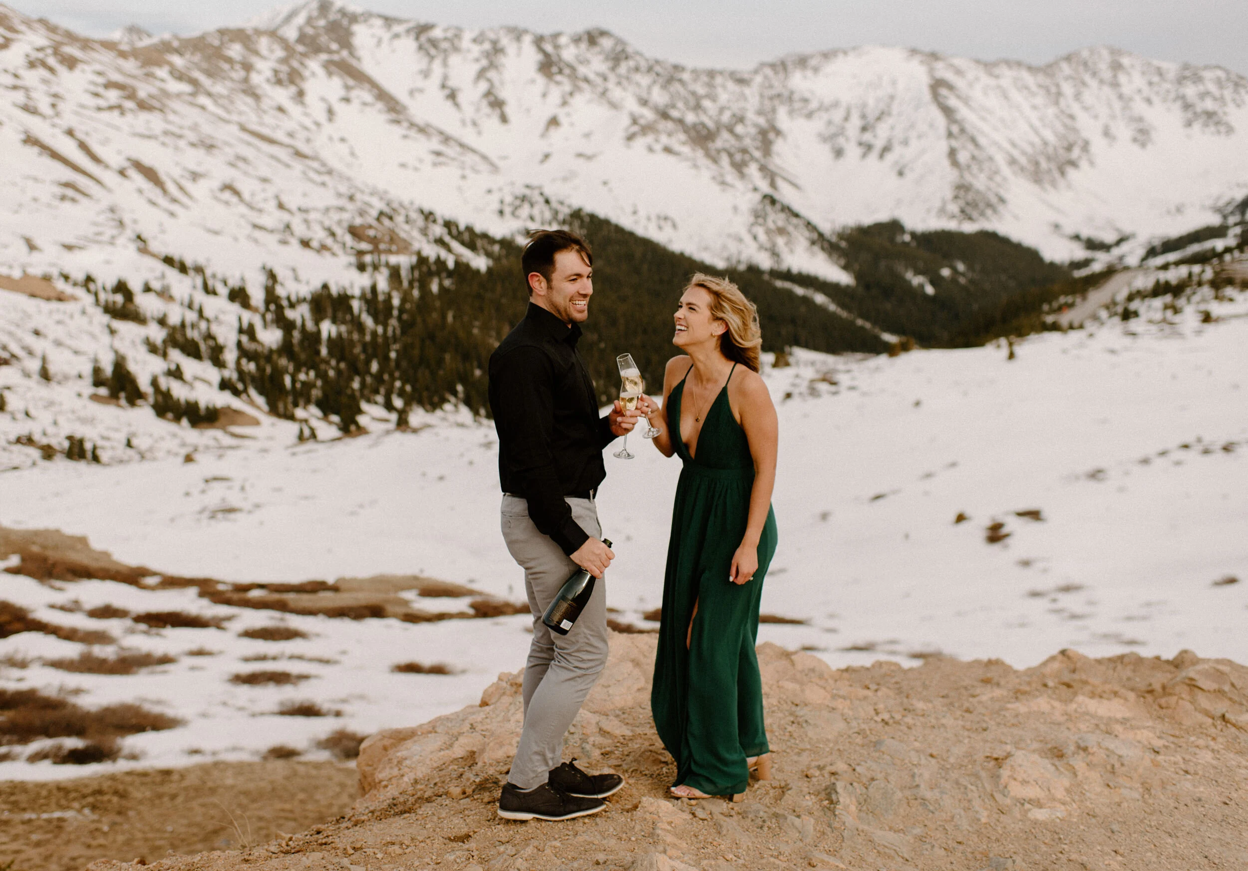  Snowy engagement session on Loveland Pass. Loveland Pass engagement photos. Champagne engagement photo ideas. Colorado wedding photographer. Colorado mountain engagement session. Colorado wedding photography. Save the date inspiration with champagne.  