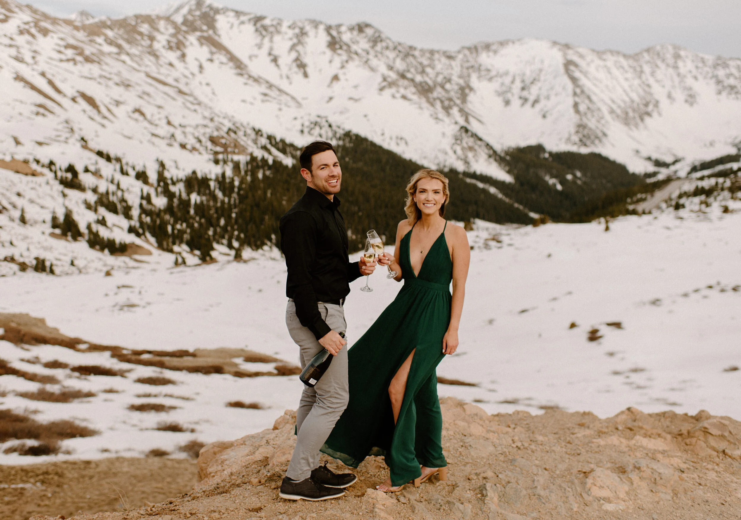  Snowy engagement session on Loveland Pass. Loveland Pass engagement photos. Champagne engagement photo ideas. Colorado wedding photographer. Colorado mountain engagement session. Colorado wedding photography. Save the date inspiration with champagne.  Engagement session dress inspiration.  