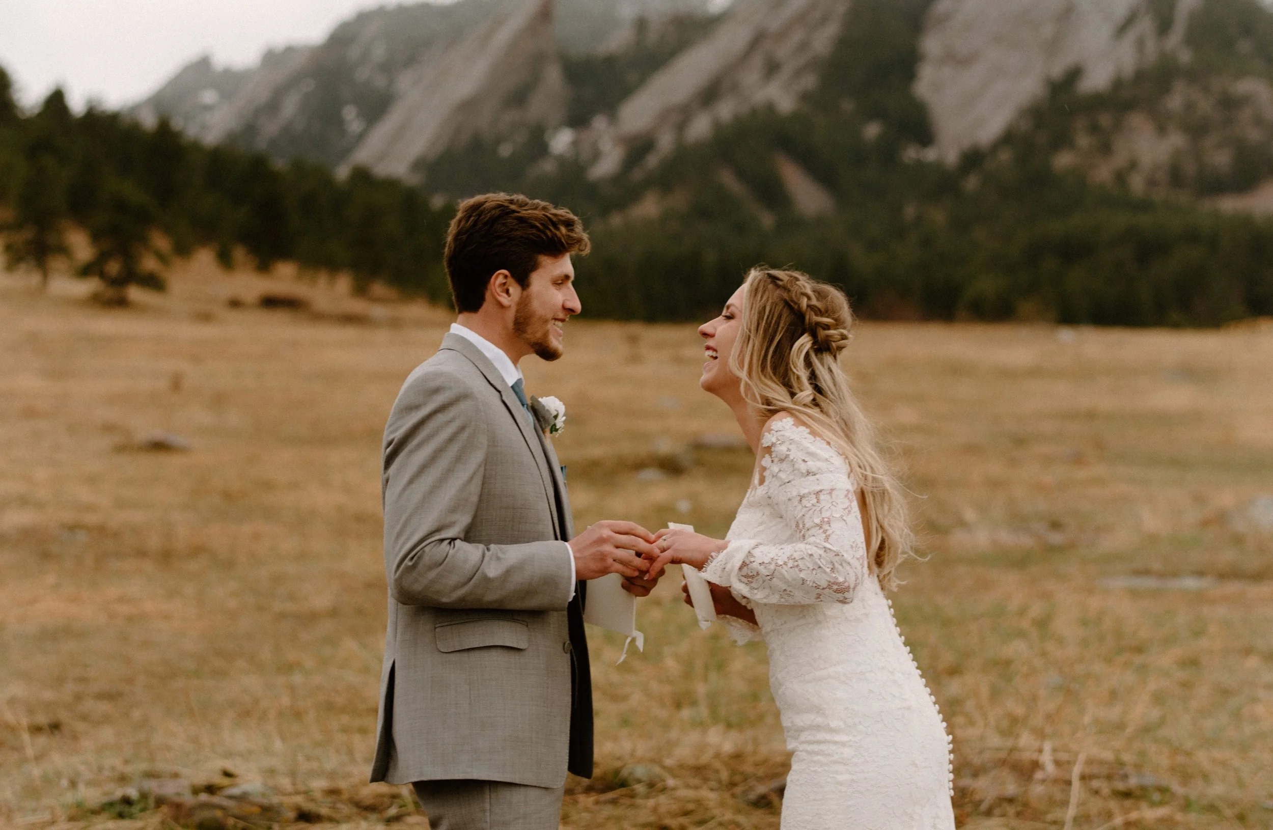 Colorado elopement in Boulder. Colorado wedding at the Flatirons near Chautauqua Park. Bride and groom exchanging wedding vows. Bride and groom exchanging rings.