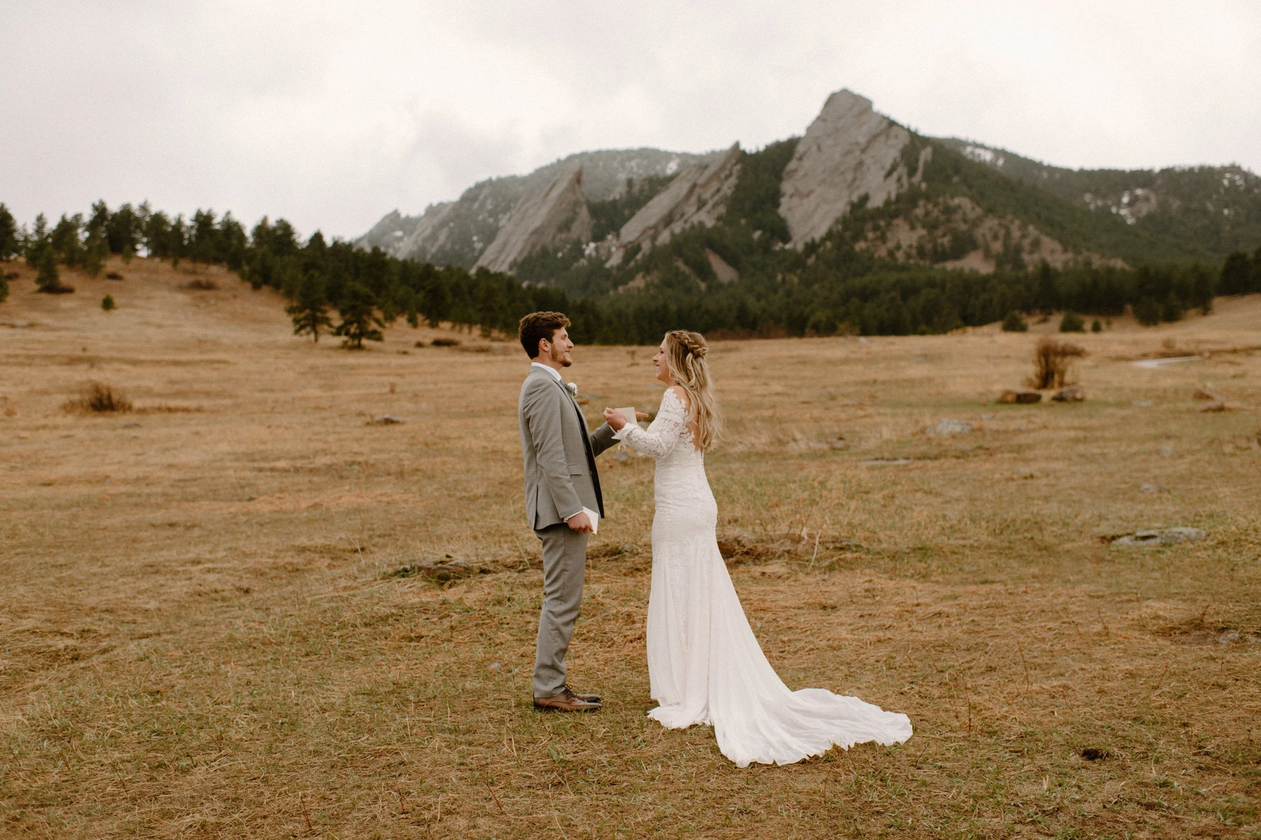 Colorado elopement in Boulder, Colorado at the Flatirons near Chautauqua Park. Bride and groom exchanging wedding vows. Bride and groom exchanging rings. Colorado wedding photographer.